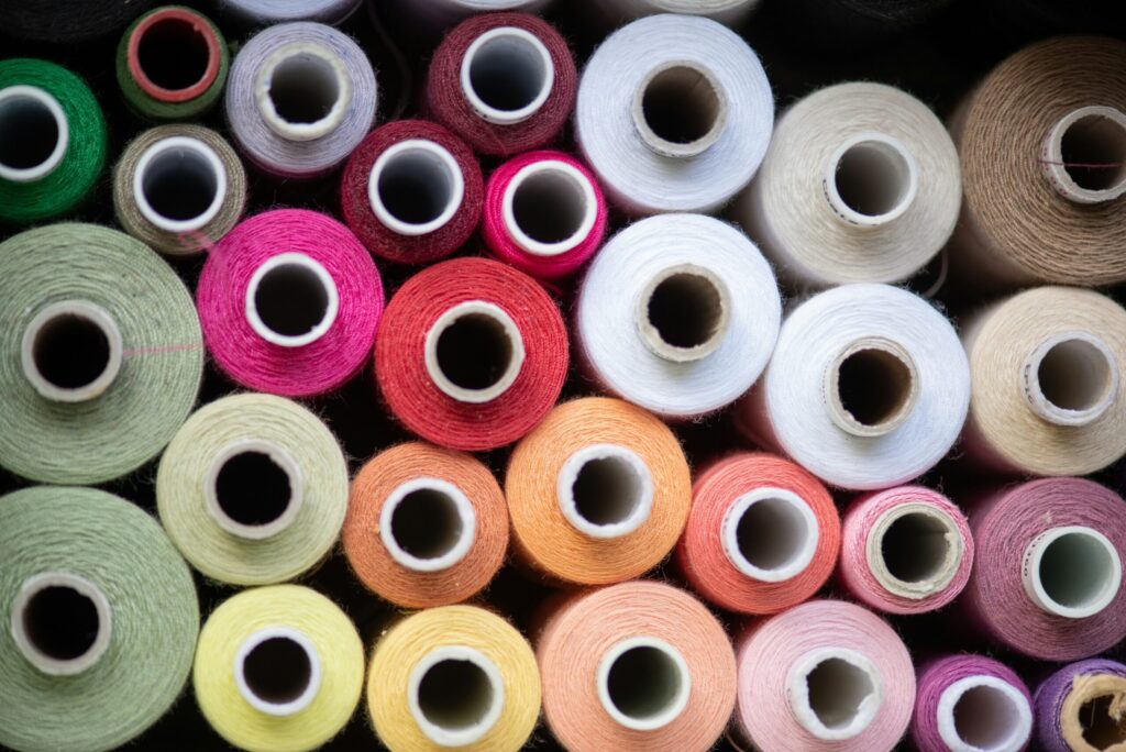 spools of different colored thread stacked onto each other